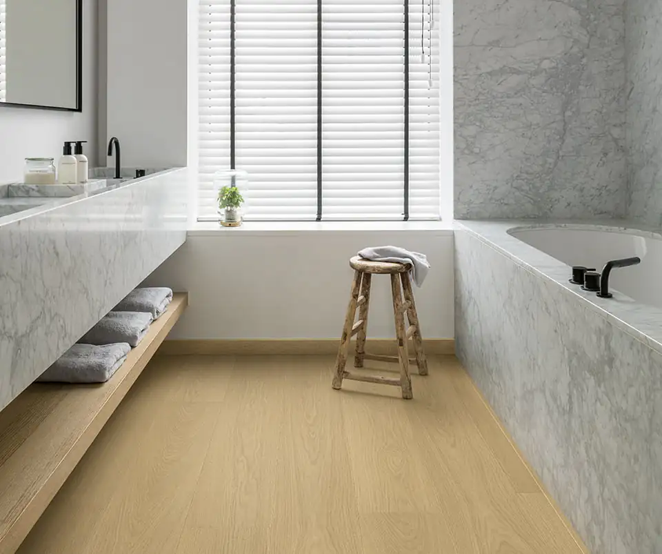Quick-Step SIG4750 natural oak laminate flooring in marble bathroom