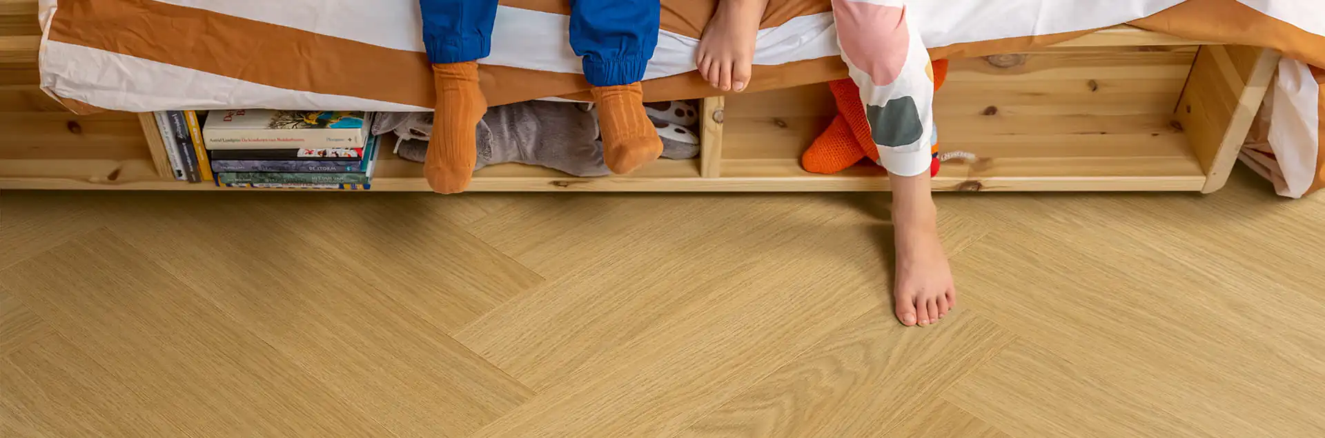 Natural oak herringbone vinyl flooring in children's bedroom, kid-friendly style