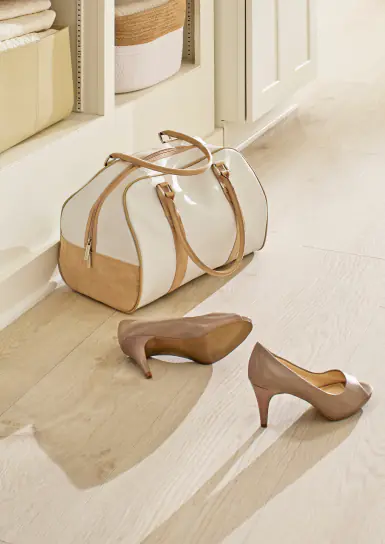 Krono Swiss light beige oak laminate flooring in bright hallway with accessories