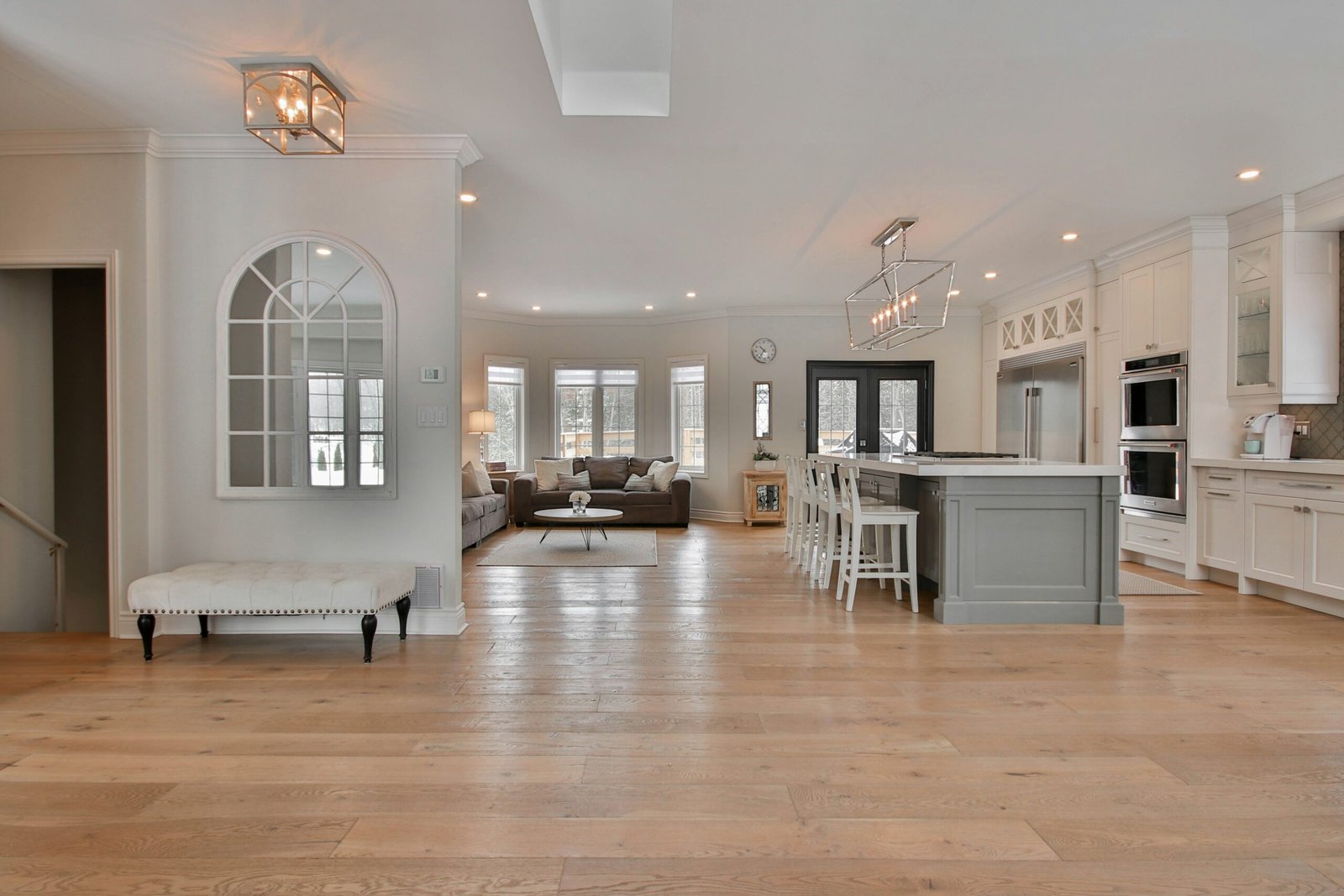 Wide-plank light oak engineered wood flooring in a bright open-plan living space