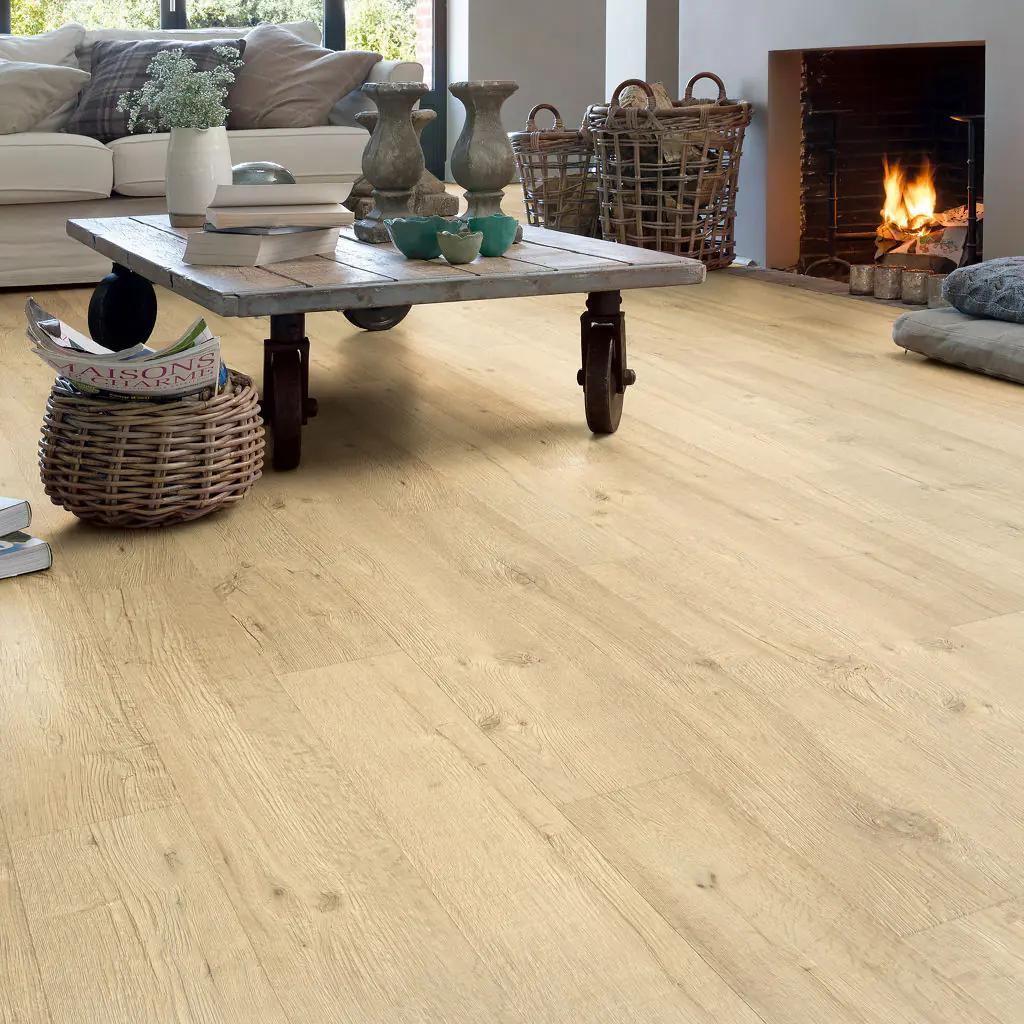 Light oak-effect plank floor in a living room with a rustic coffee table and an open fire
