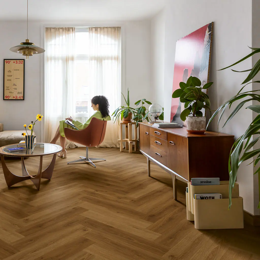 Warm medium brown oak herringbone vinyl flooring in retro-style living room