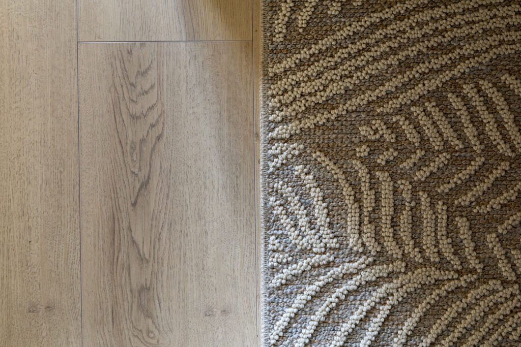 Light wood flooring meets beige textured carpet in modern home - Royal Flooring Company Ireland